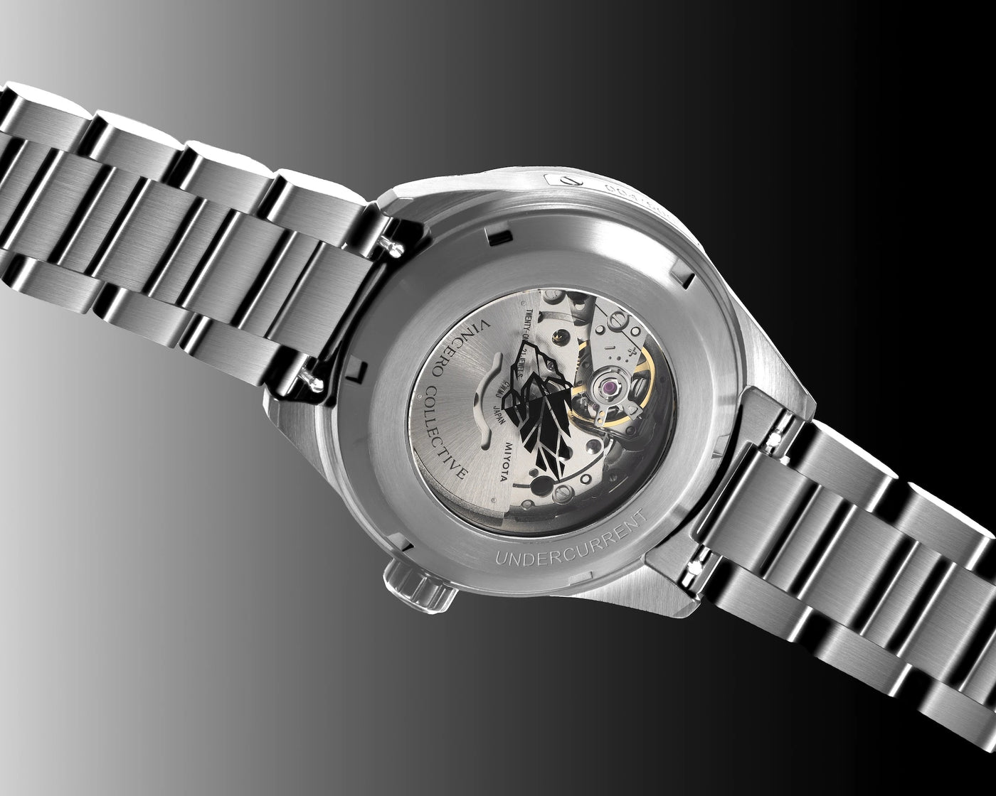 Silver watch with visible brand name on a dark background