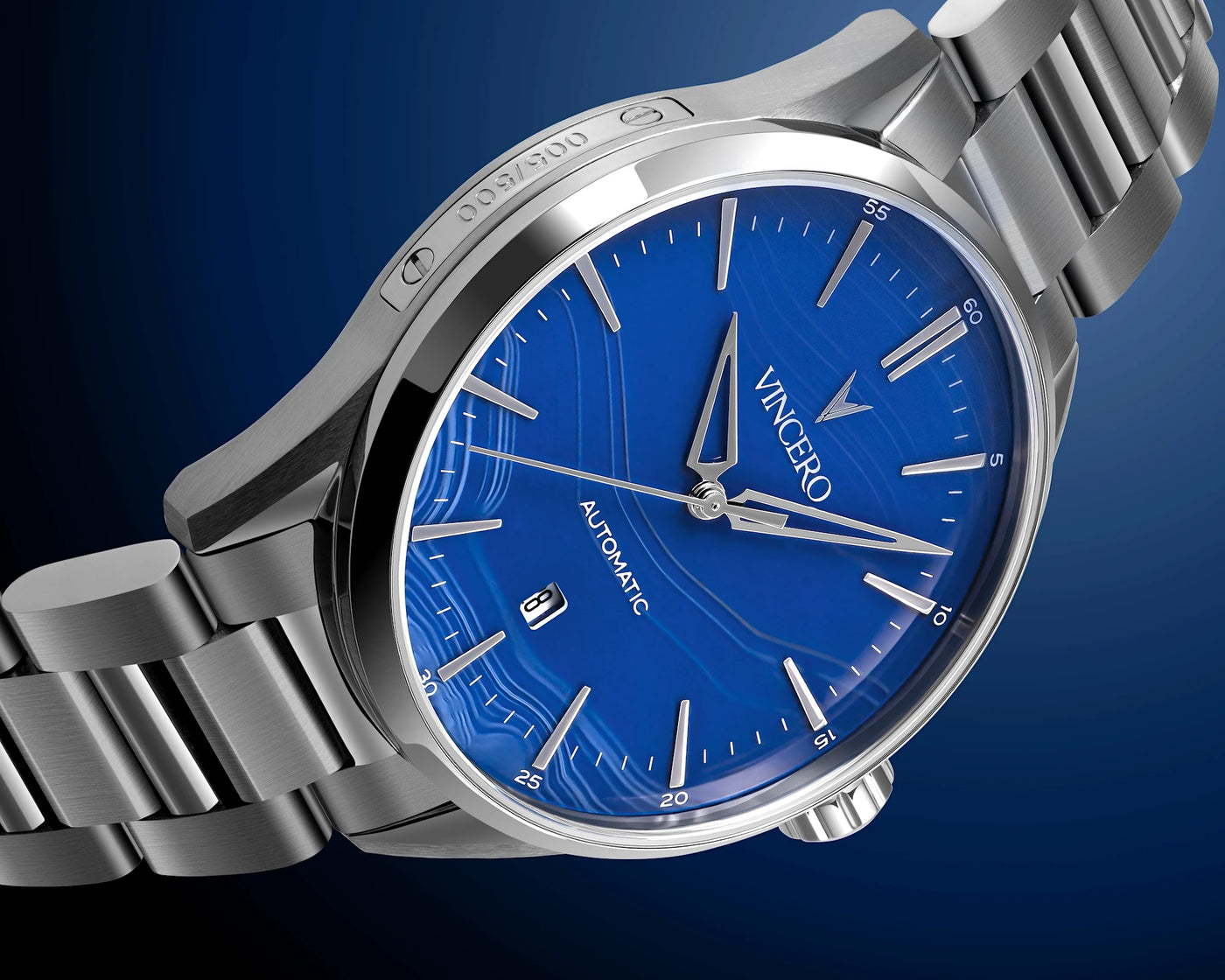 Silver watch with blue dial on a dark blue background