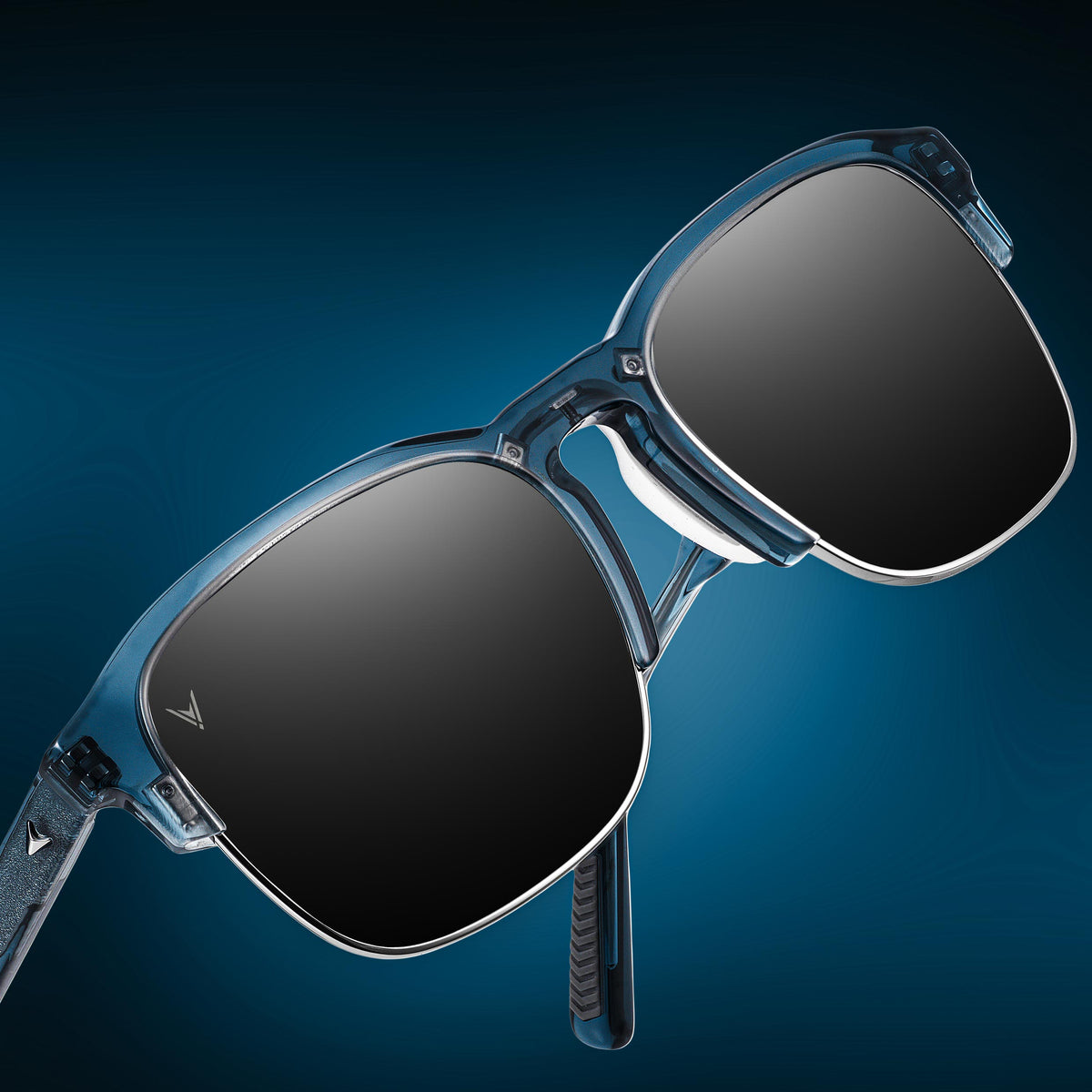 Sunglasses with blue frame and dark lenses on a gradient blue background