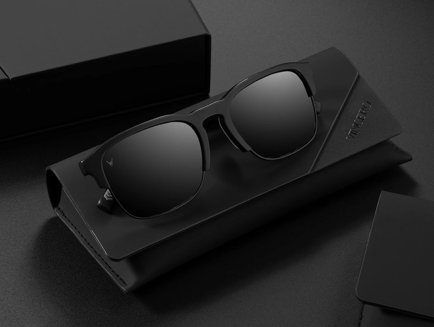 Black sunglasses in a case on a dark surface