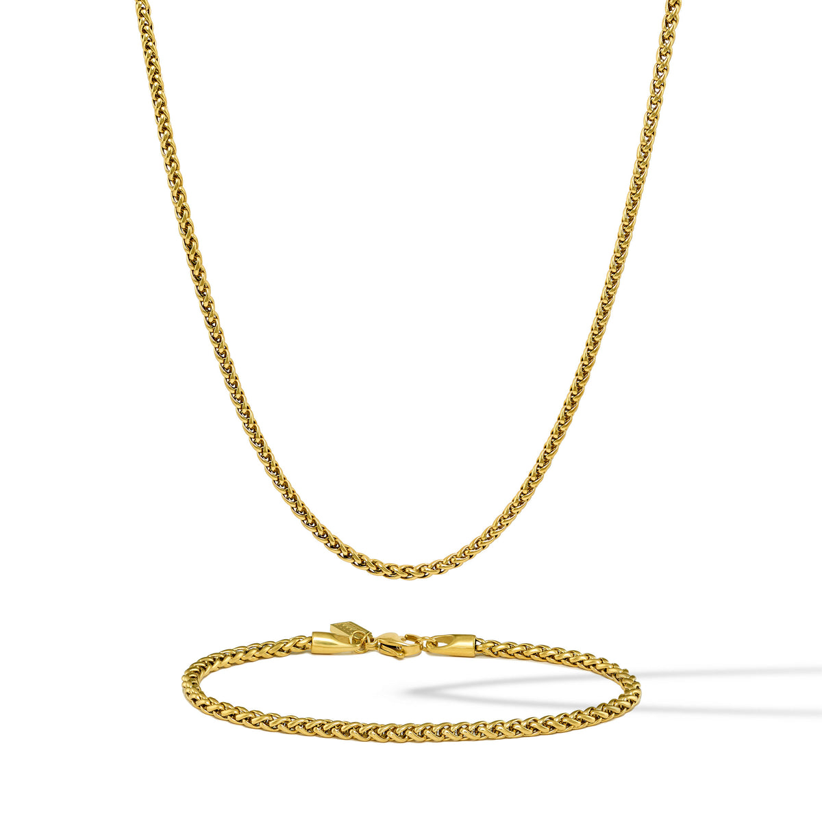 Gold chain necklace and bracelet set on a white background