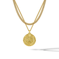 A gold double-layer necklace featuring a curb chain and a cable chain with a circular wolf pendant, shown against a plain white background with a soft shadow.
