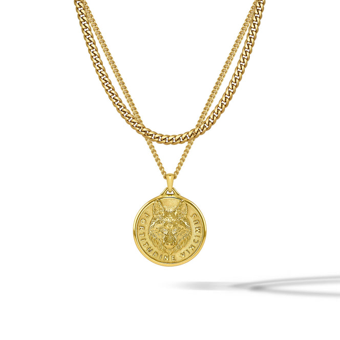 A gold double-layer necklace featuring a curb chain and a cable chain with a circular wolf pendant, shown against a plain white background with a soft shadow.